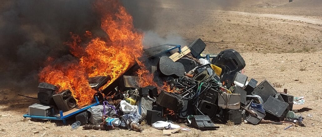 taliban-burning-musical-instruments A pile of musical instruments, including speakers and guitars, engulfed in flames in an open field under the Taliban's orders to eliminate music in Afghanistan.