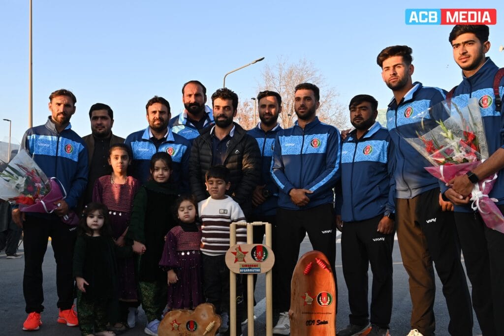 ICC Defends Afghanistan Cricket Board, Distances Sports from Government Policies A group photo of Afghan cricket players, children, and fans in Kabul, celebrating the team's success against Zimbabwe.