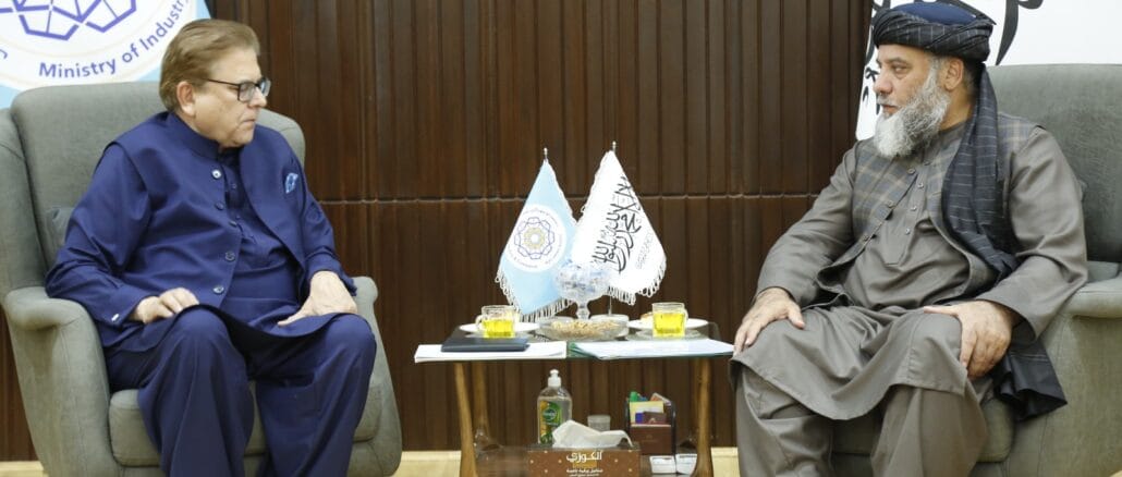 GfpChfTW8AAPw5P Mohammad Sadiq, Pakistan's Special Envoy to Afghanistan, seated on the left, meets Nooruddin Azizi, Afghanistan’s Commerce Minister, on the right. They sit in a formal setting, with flags and a table between them, discussing trade and economic cooperation.